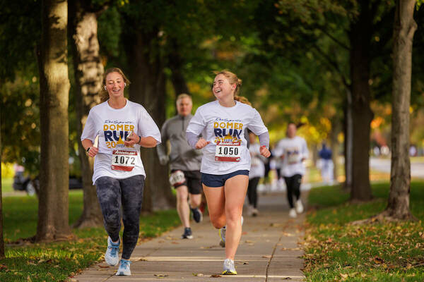 Two women running the domer run