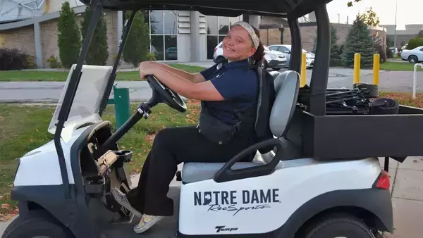 RecSports student staff member on a golf cart